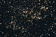 © Ira_Shpiller - Golden star glitter confetti on dark black background. Festive holiday background. Celebration concept.
