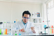 © Nawarit - Asian scientists are preparing chemicals for testing and analysis in the laboratory. Scientists clear glasses and white shirts. Science and Chemistry Concept