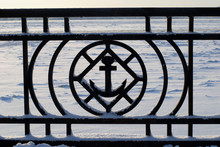 Close-up Cast-iron Fence With Anchor On The Embankment