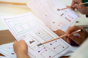 Wall Mural - designer female creating application user experience ux website, ui app development on smartphone mo