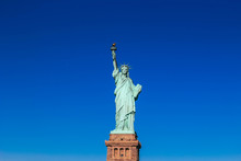 STATUE OF LIBERTY AGAINST BLUE SKY