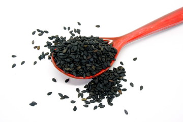 Wall Mural - Black sesame seeds in a brown wooden spoon