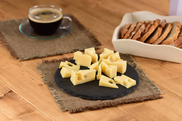 Cheese on a slate plate on the wooden table