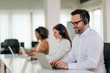 © bnenin - Positive entrepreneur working with headset and laptop, portrait.