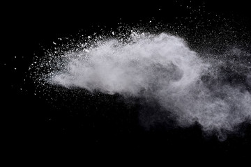 Wall Mural - freeze motion of white color powder exploding on dark background.