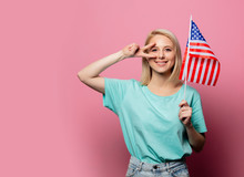 Beautiful Blonde Woman With USA Flag On Pink Background