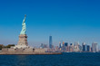 Statue Of Liberty By River Against Clear Sky