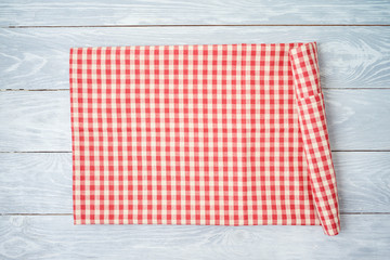 Wall Mural - Red checked tablecloth on rustic wooden table. Kitchen, cooking or baking mock up background for design.