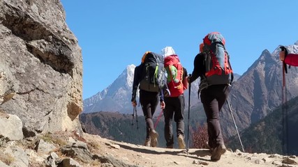 group of hikers hiking in the mountains alone the trekking road to everest base camp in nepal