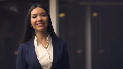 Wall Mural - The beautiful asian businesswoman walking indoor. slow motion