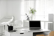 © New Africa - Doctor's workplace with laptop in modern clinic