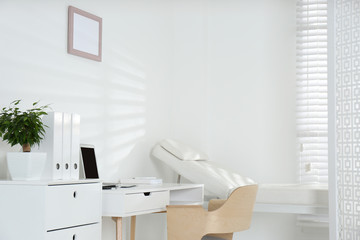 Sticker - Doctor's office interior with examination couch and desk