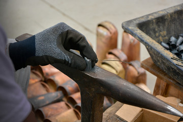 Sticker - Hand with black glove working in cowbell manufacturing workshop