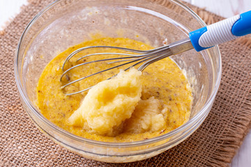 Wall Mural - Grated apple and raw egg in a glass bowl. Making cupcake