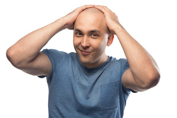 Wall Mural - Photo of happy bald man touching shaved head