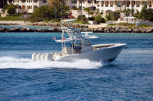 White Sport Fishing Boat With Flying Bridge Powered By Four Outboard Engines.