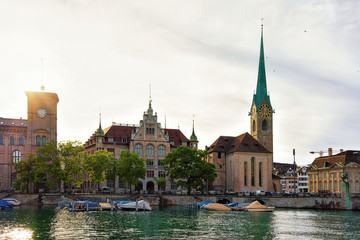 Poster - Fraumunster Church and boats Limmat River quay in the city center of Zurich, Switzerland. People on the background