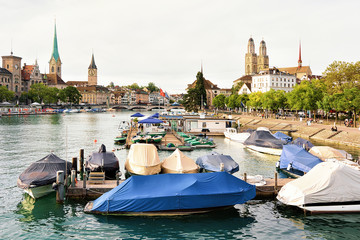 Poster - Grossmunster, St Peter Church and Fraumunster Church, and boats at Limmat River quay in the city center of Zurich, Switzerland. People on the background