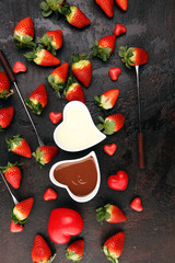 Wall Mural - Valentine Chocolate fondue melted with fresh strawberries and dark and white chocolate. Red roses and sugar hearts for Valentines Day. Valentine Background