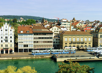 Wall Mural - Zurich, Switzerland - September 2, 2016: Trams at Limmatquai in the city center of Zurich, Switzerland. People on the background. Seen from Lindenhof hill