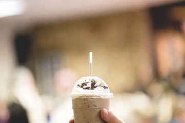 Poster - Man holding cols tasty frappe with blurred background