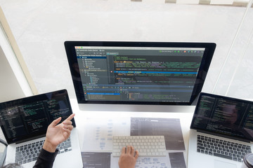 Wall Mural - programmers work on the development of coding and coding technology on white desks and website desig