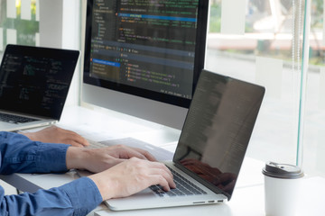 Wall Mural - programmers work on the development of coding and coding technology on white desks and website desig