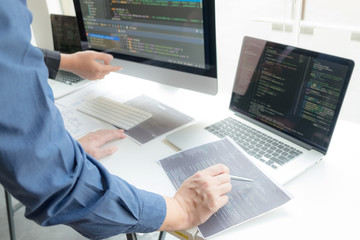 Wall Mural - programmers work on the development of coding and coding technology on white desks and website desig