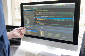 Wall Mural - programmers work on the development of coding and coding technology on white desks and website desig