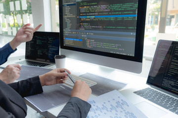 Wall Mural - programmers work on the development of coding and coding technology on white desks and website desig