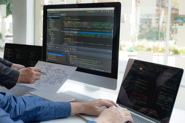Wall Mural - programmers work on the development of coding and coding technology on white desks and website desig