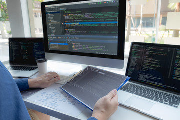 Wall Mural - programmers work on the development of coding and coding technology on white desks and website desig