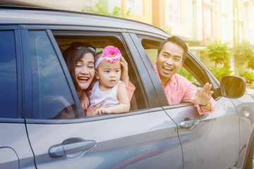 Wall Mural - Parents and cute child looking out car windows