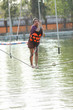© nitimongkolchai - Young teenage girl walking on tight rope over the water