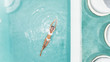 © Alena Ozerova - Woman relaxing in clear pool water in hot sunny day on Bali villa