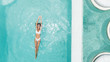 © Alena Ozerova - Woman relaxing in clear pool water in hot sunny day on Bali villa