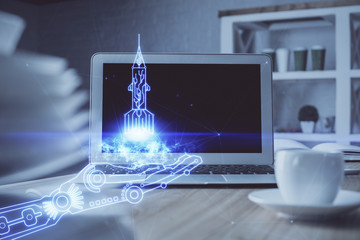 Desktop computer background in office and start up theme hologram drawing. Double exposure. Startup concept.