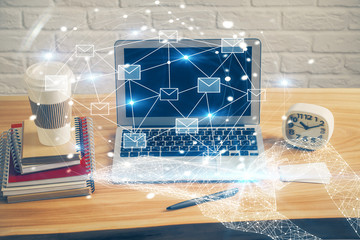 Desktop computer background in office and flying envelops hologram drawing. Multi exposure. Electronic mail concept.