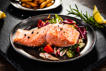 Roasted salmon with french fries and vegetable salad