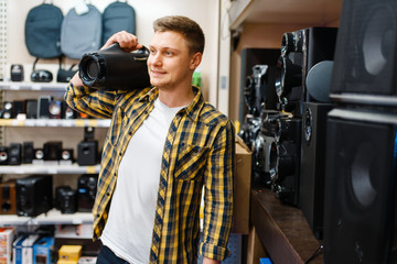 Wall Mural - Man choosing music system in electronics store