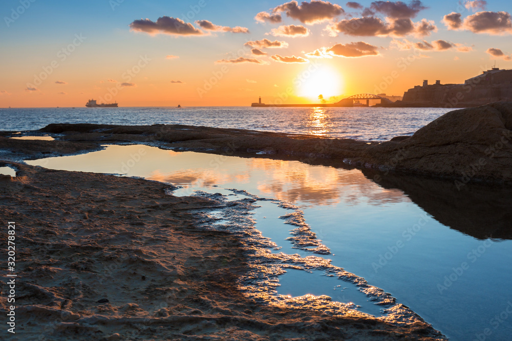Rocky coastline of Malta and Mediterranean Sea at sunrise - obrazy, fototapety, plakaty 