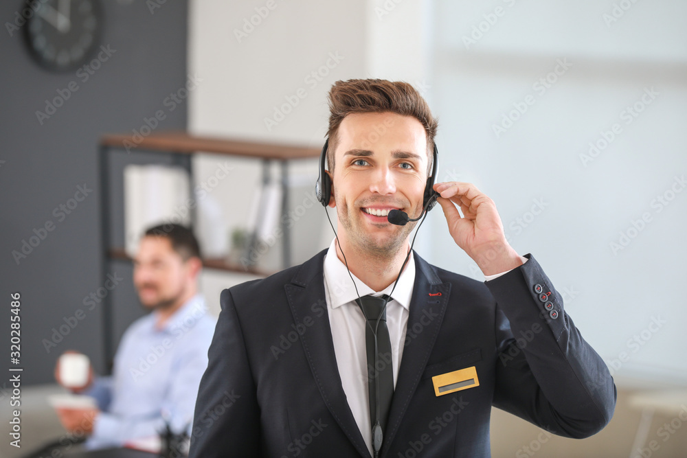 Portrait of male receptionist in office