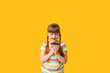 © Pixel-Shot - Funny little girl with donut on color background