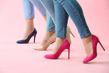 Legs Of Beautiful Young Women On Color Background