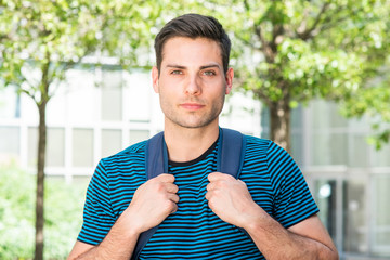 Wall Mural - Close up handsome young man with backpack outside