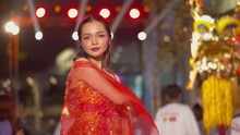 Beautiful Asian Girl Wearing A Tradional Red, Sleeveless Dress Poses By The Golden Dragon During The Chinese New Year Celebration With Bokeh Of The Night Lights In The Background