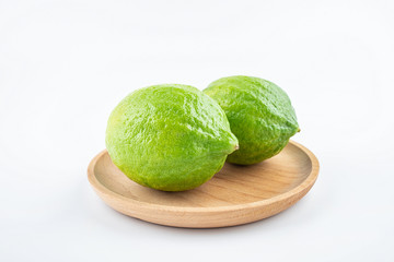 Fresh green lemon on white background