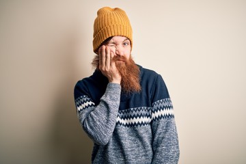 Canvas Print - Handsome Irish redhead man with beard wearing winter sweater and wool hat thinking looking tired and bored with depression problems with crossed arms.