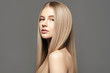 © Beauty Agent Studio - Beautiful young woman with long healthy hair posing against grey background. Beauty salon concept