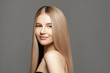 © Beauty Agent Studio - Hairl care shampoo.Beautiful young woman with long healthy hair posing against grey background. Beauty salon concept
